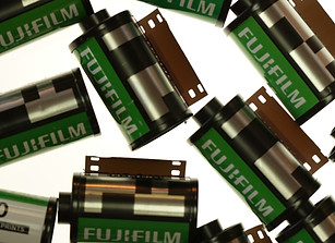 Several Fujifilm film backs scattered; Fujifilm text visible; for the shutterbug.