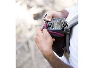 Photographer adjusting camera strap with blurred background theshutterbug nature photography