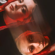 Woman with red hands covers her head in a dark setting theshutterbug